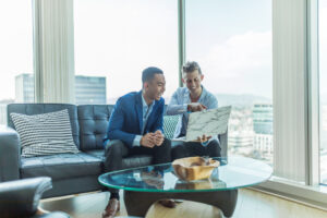 two startup founders meeting and looking at one laptop