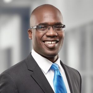 Portrait of Konata lake in business wear with blue tie, black blazer, white button-up and glasses
