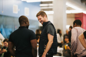Mike Murchison talking with another guest. - DMZ Founder Dinner recap