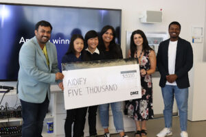 DMZ Basecamp 2023 participants, Aidify, pose with their $5000 cheque
